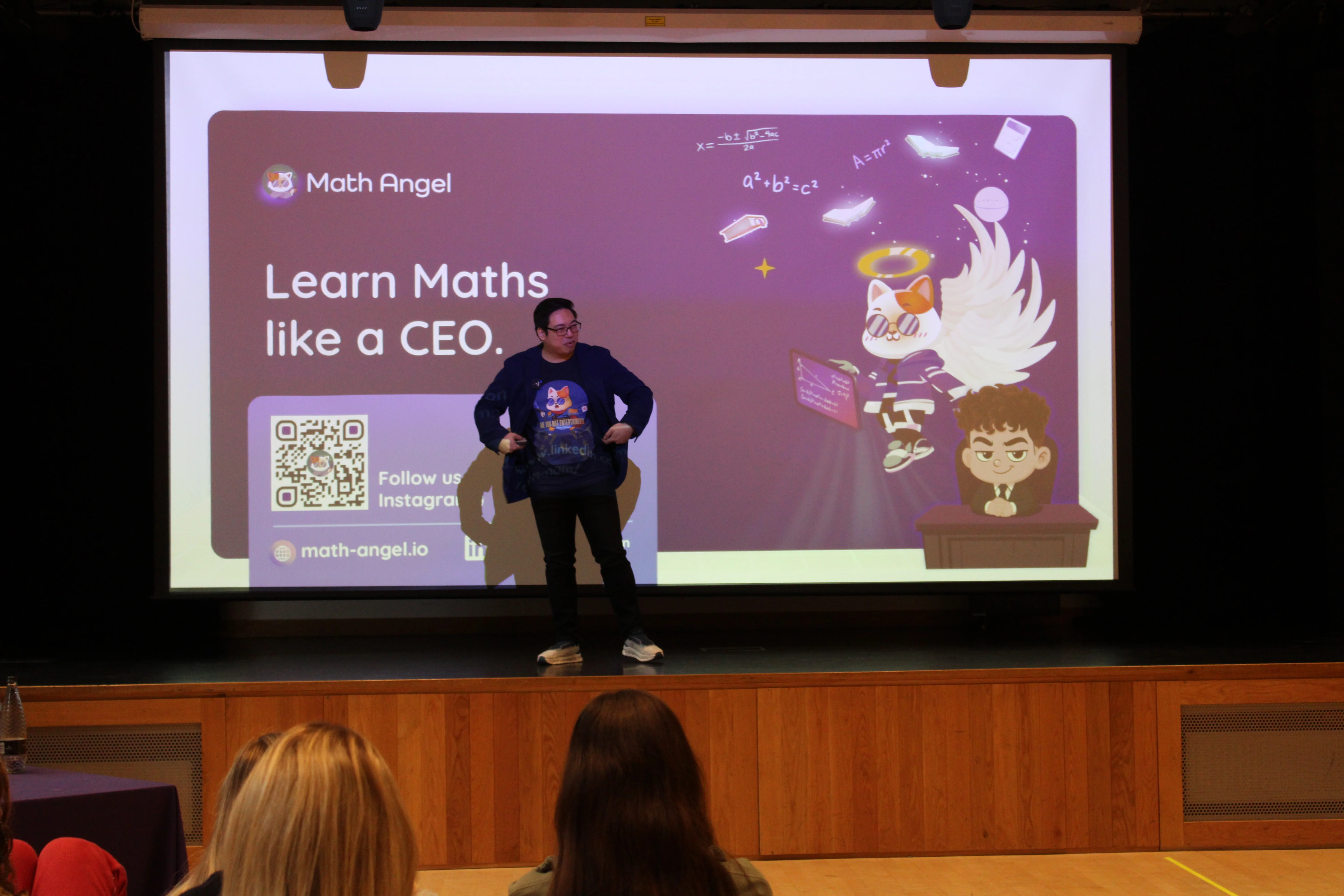 An-Nam Pham, Co-Founder and CTIO of Maths Angel, presenting on stage at a school in London